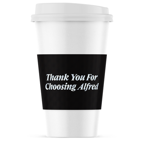 A white paper coffee cup with a black sleeve featuring the white text 'Thank You For Choosing Alfred' on a clean white background.